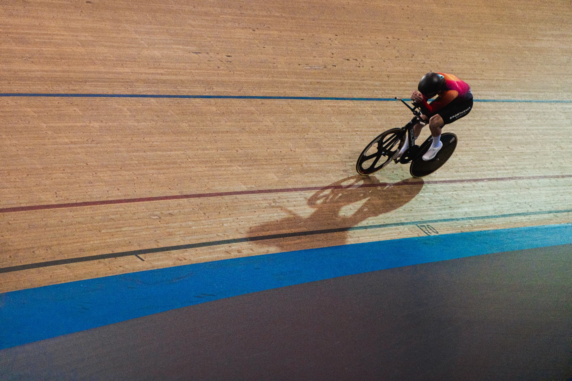 Rider in a custom Sportkraft aero skinsuit on the velodrome, seen from above