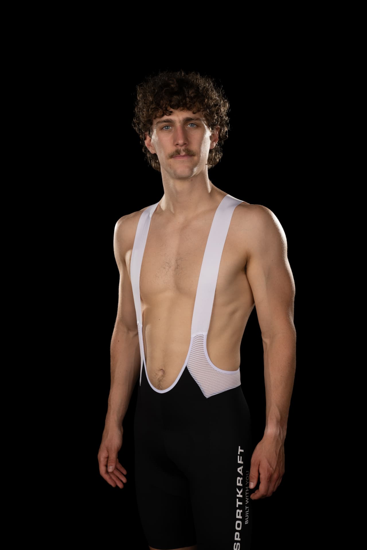 Rider wearing black SPORTKRAFT Race 2.1 Bib Shorts with white straps