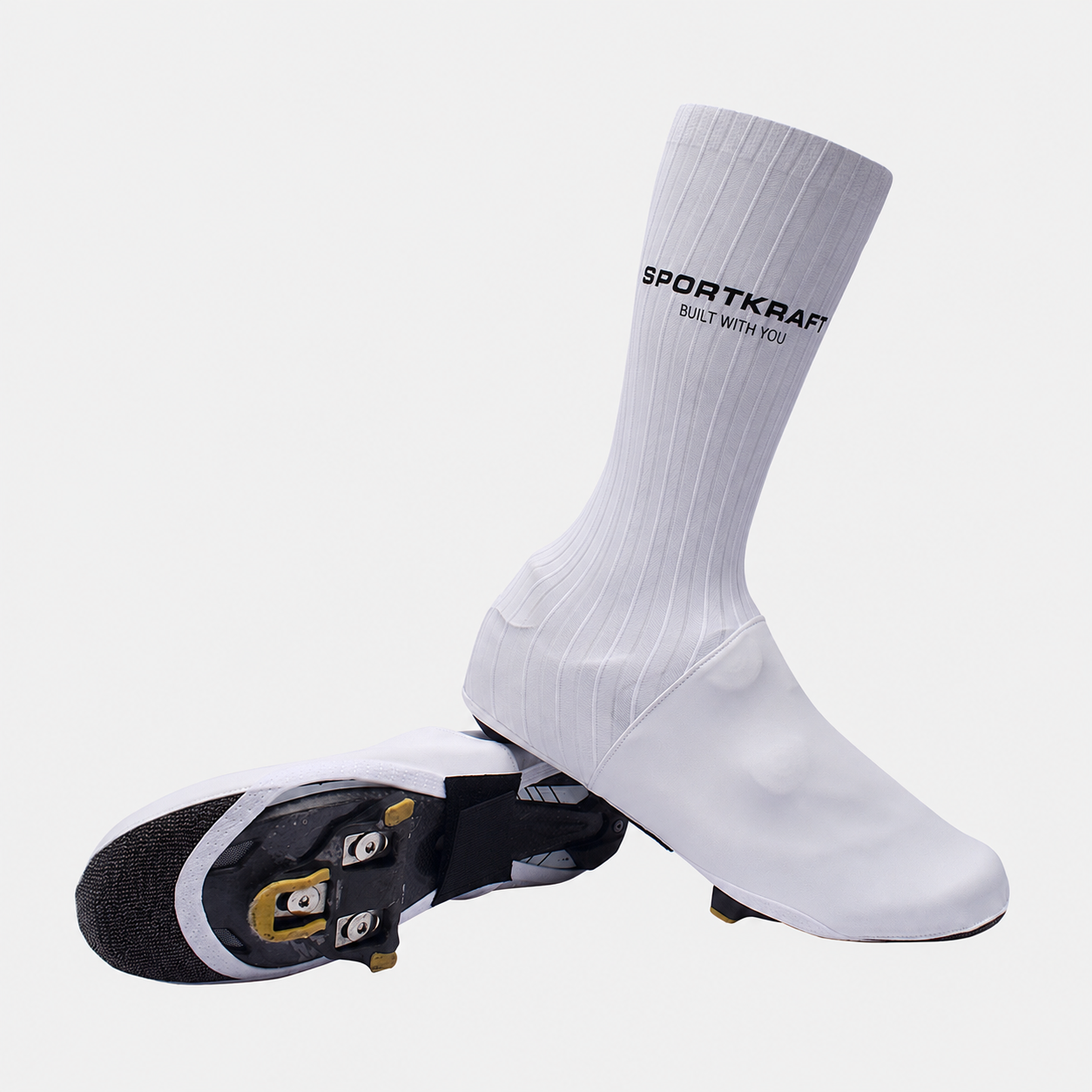White SPORTKRAFT Aero 3.1 Shoe Covers with ribbed upper and horizontal SPORTKRAFT logo, shown over cycling shoes